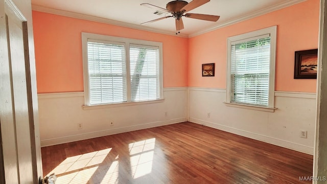 spare room featuring ornamental molding, hardwood / wood-style flooring, ceiling fan, and a wealth of natural light