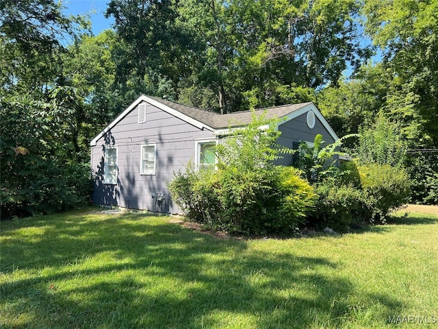 view of side of home with a lawn