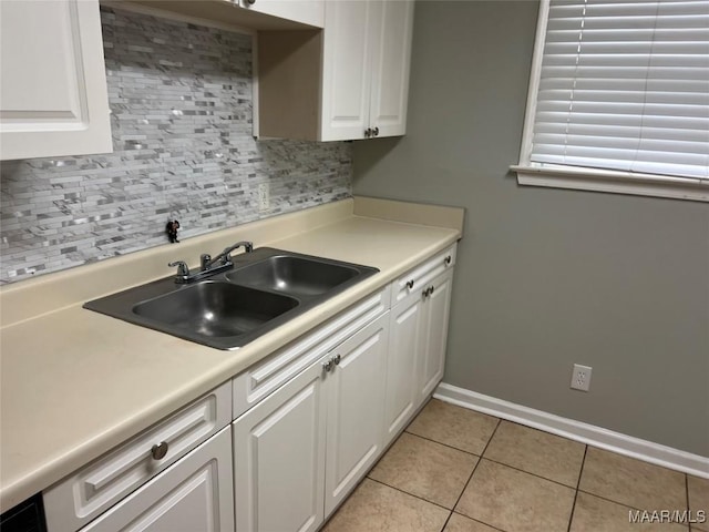 kitchen with white cabinetry, sink, decorative backsplash, and light tile patterned flooring