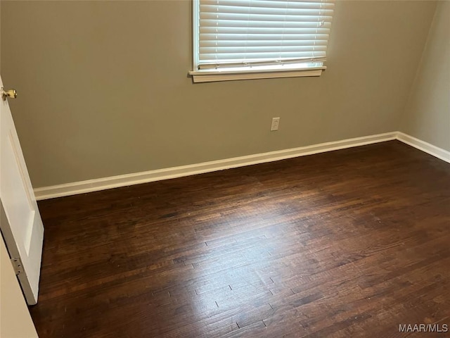 empty room with dark wood-type flooring