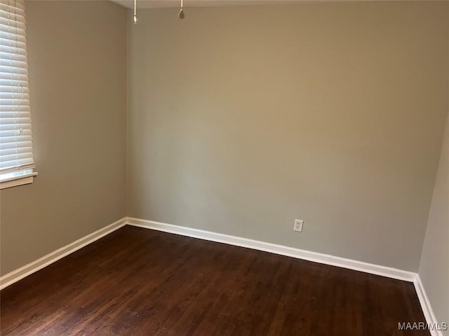 unfurnished room featuring dark hardwood / wood-style flooring