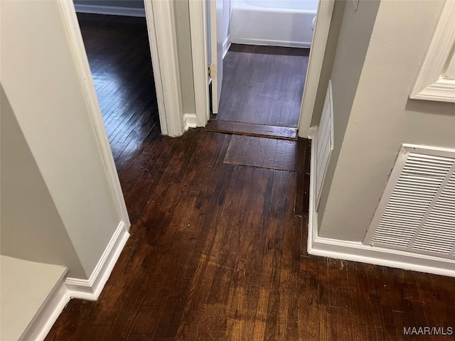 hall with hardwood / wood-style floors