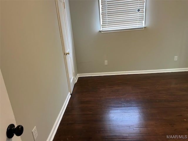 spare room with dark hardwood / wood-style floors