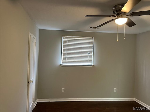 empty room with ceiling fan and dark hardwood / wood-style floors