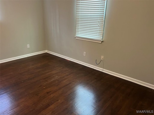 spare room with dark hardwood / wood-style flooring