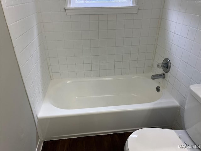 bathroom with shower / tub combination, wood-type flooring, and toilet