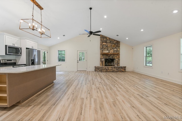 kitchen featuring white cabinets, light wood-type flooring, stainless steel appliances, and plenty of natural light