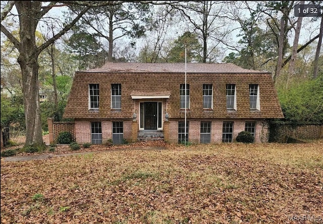 raised ranch with a front lawn