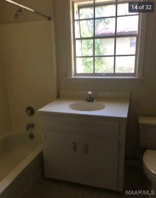 full bathroom featuring shower / bath combination, toilet, and vanity