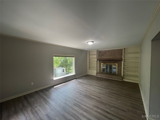 unfurnished living room featuring crown molding, dark wood-type flooring, and a fireplace