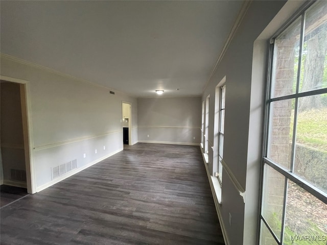 unfurnished room featuring dark hardwood / wood-style floors and ornamental molding