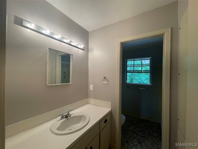 bathroom featuring vanity, toilet, and tile patterned flooring