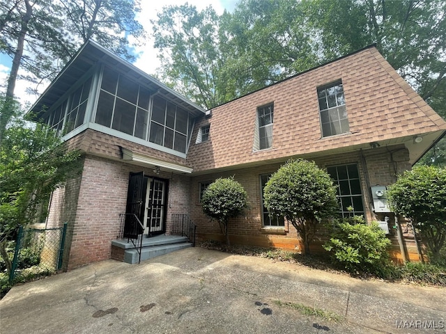 back of house featuring a sunroom