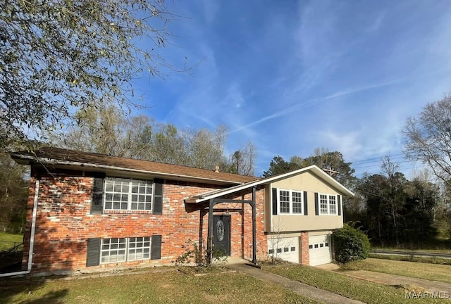 split foyer home with a garage and a front lawn