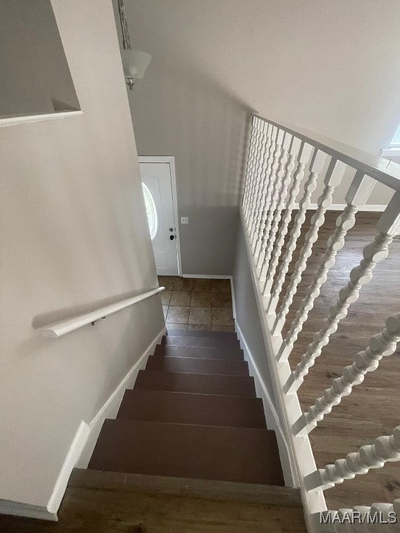 stairs featuring hardwood / wood-style floors