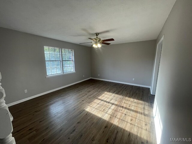 14 Azaleawood Dr, Wetumpka, AL 36093 - empty room with a ceiling fan, dark wood-type flooring, and baseboards