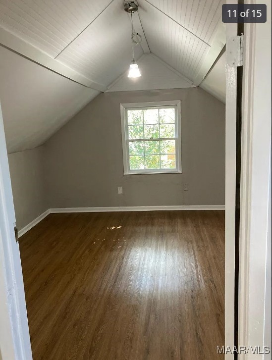 additional living space featuring wood ceiling, vaulted ceiling, and dark hardwood / wood-style flooring