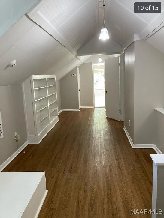 bonus room featuring vaulted ceiling and dark hardwood / wood-style flooring