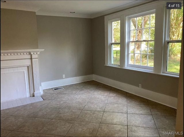 unfurnished living room with tile patterned flooring and ornamental molding