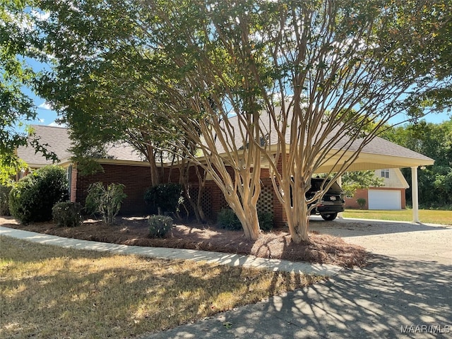 view of front of home with a garage and a carport