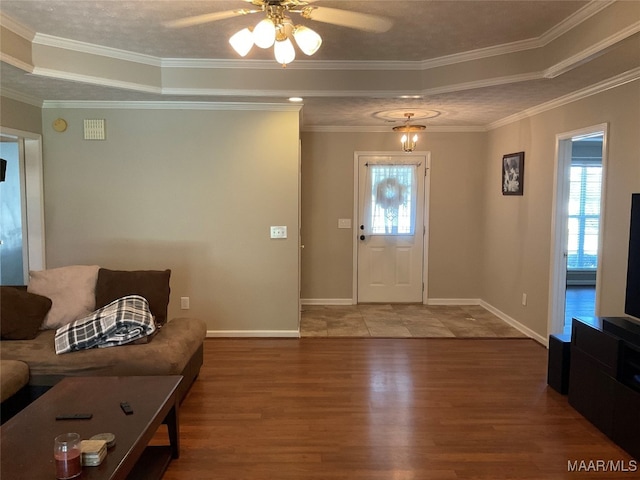 living room with ceiling fan, crown molding, and a healthy amount of sunlight