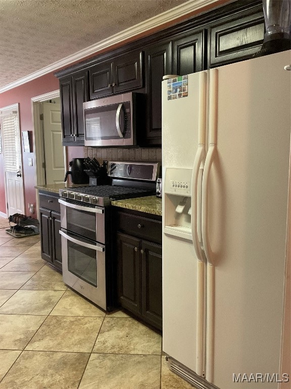 kitchen with crown molding, a textured ceiling, tasteful backsplash, light tile patterned floors, and appliances with stainless steel finishes