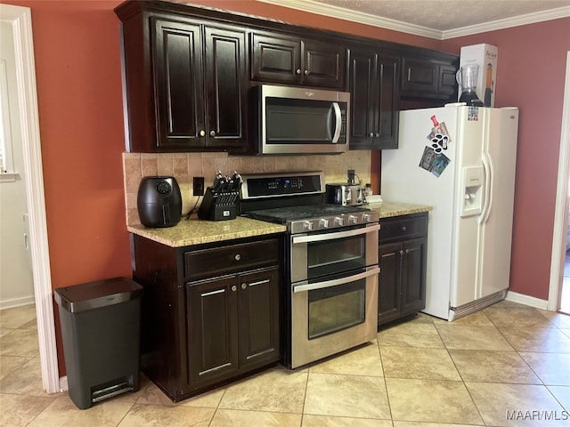 kitchen with crown molding, tasteful backsplash, dark brown cabinets, light tile patterned floors, and appliances with stainless steel finishes