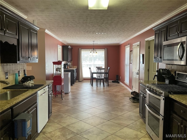 kitchen featuring crown molding, pendant lighting, light tile patterned floors, and stainless steel appliances