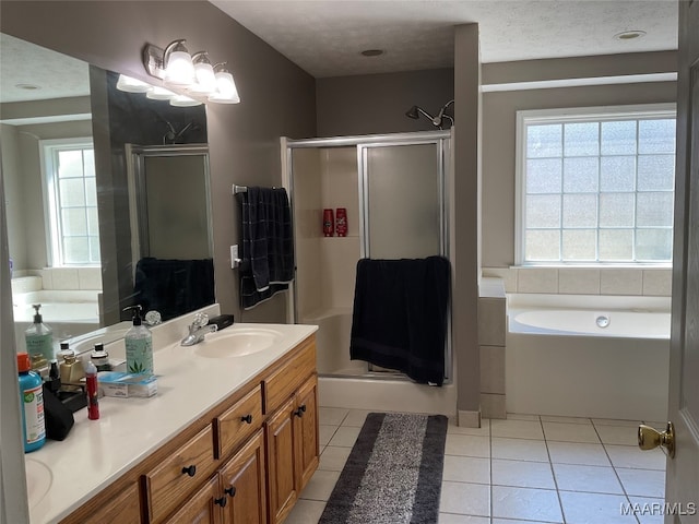 bathroom with tile patterned flooring, vanity, plus walk in shower, and a textured ceiling