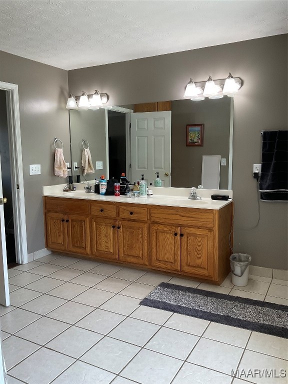 bathroom featuring vanity, a textured ceiling, and tile patterned flooring