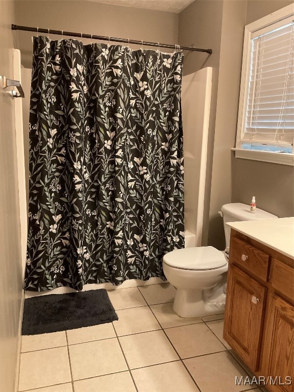 bathroom with vanity, toilet, and tile patterned flooring