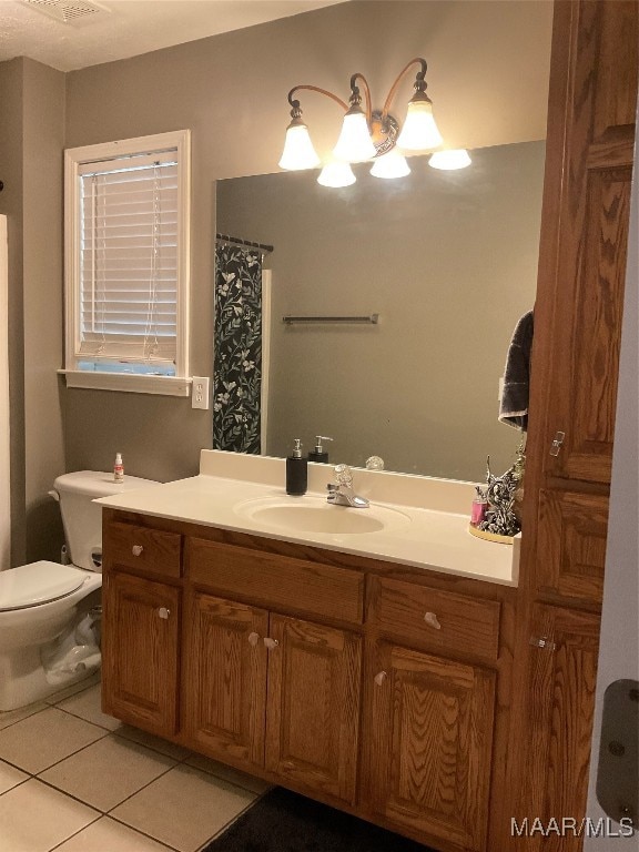 bathroom with tile patterned floors, toilet, and vanity