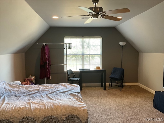 carpeted bedroom with ceiling fan and vaulted ceiling