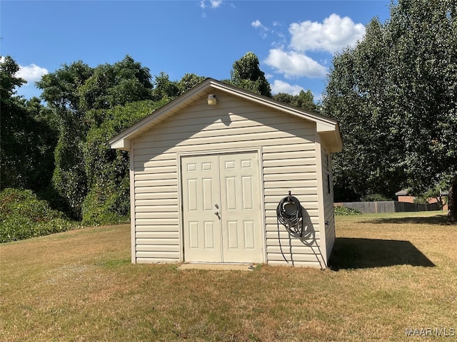 view of outdoor structure featuring a lawn