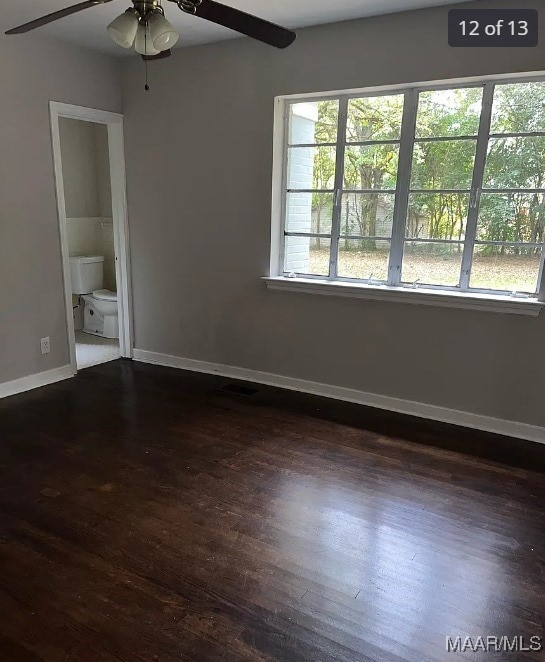 unfurnished room with ceiling fan and dark hardwood / wood-style floors