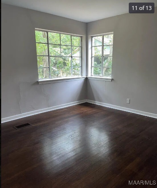 empty room with dark wood-type flooring