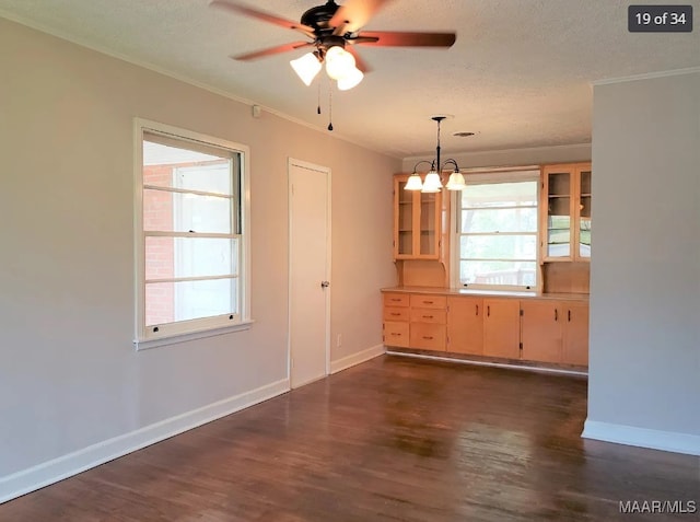 unfurnished room featuring a textured ceiling, ceiling fan with notable chandelier, and dark wood-type flooring