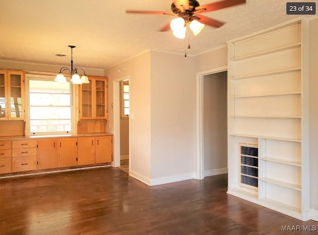 unfurnished living room with a textured ceiling, ceiling fan with notable chandelier, ornamental molding, and dark hardwood / wood-style floors