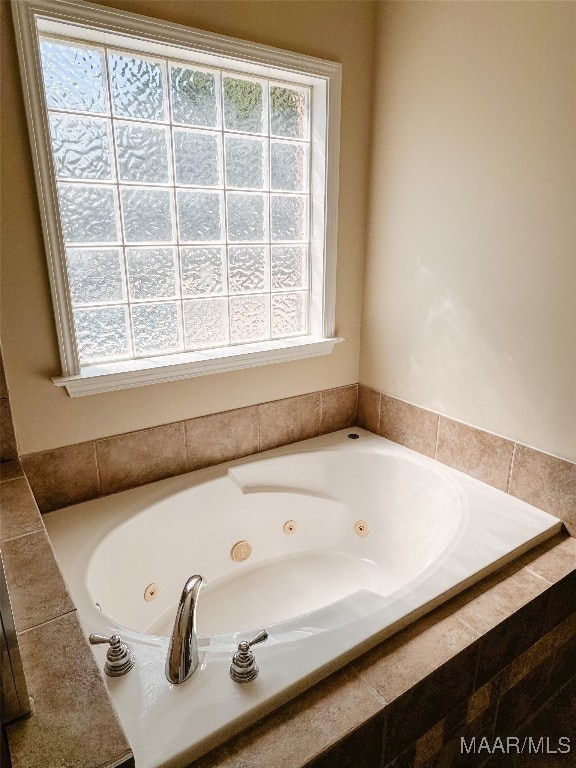 bathroom featuring a relaxing tiled tub