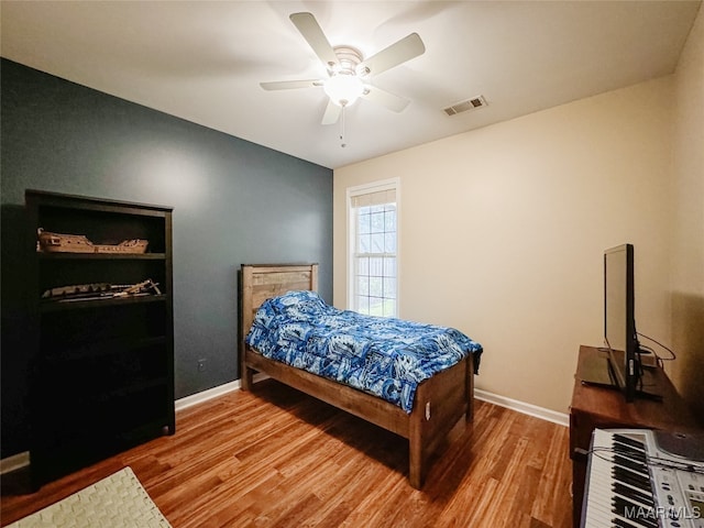 bedroom featuring ceiling fan and hardwood / wood-style flooring