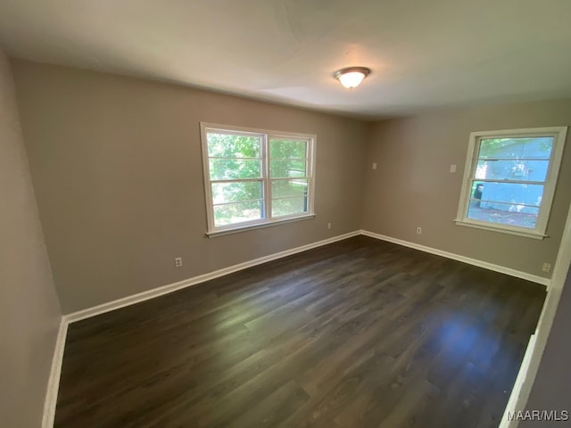 empty room featuring dark hardwood / wood-style flooring