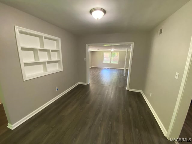 hallway with dark hardwood / wood-style floors