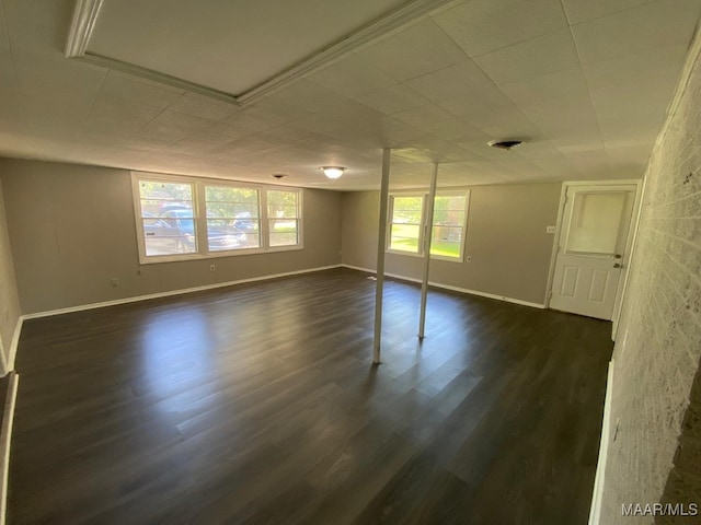 unfurnished room with plenty of natural light and dark wood-type flooring