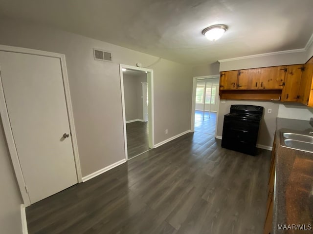 kitchen with crown molding, sink, dark wood-type flooring, and black range with electric stovetop