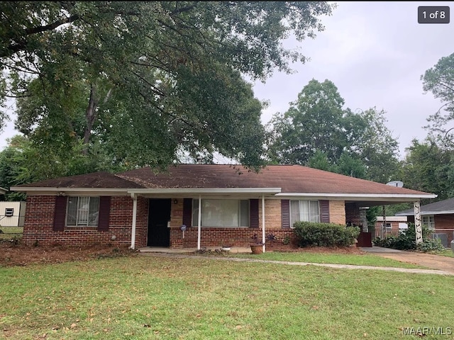 ranch-style home with a front lawn and covered porch