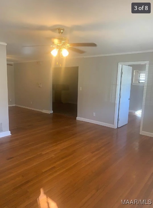 empty room featuring ornamental molding, dark hardwood / wood-style flooring, and ceiling fan