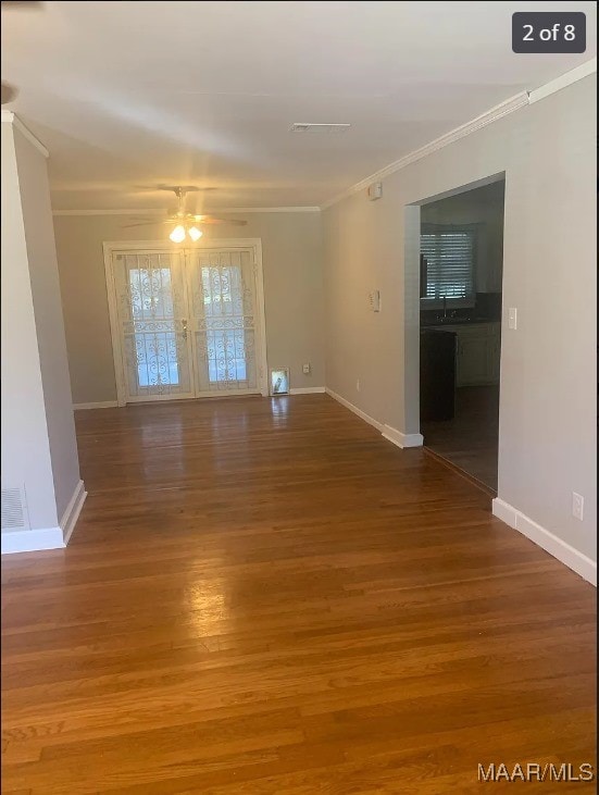 empty room featuring wood-type flooring, ceiling fan, french doors, ornamental molding, and sink