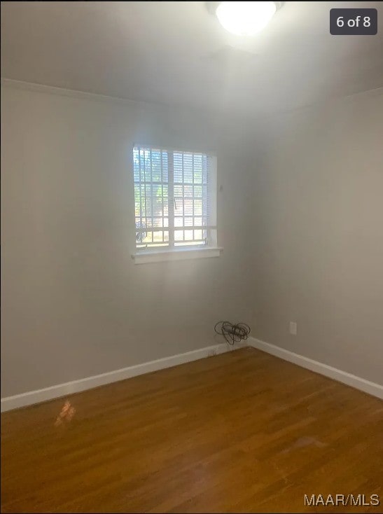 spare room with wood-type flooring