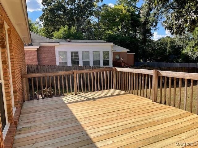 wooden terrace featuring fence