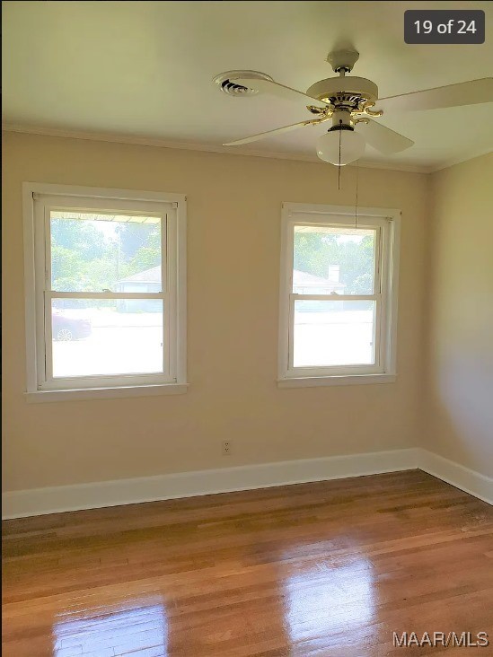 unfurnished room featuring ceiling fan, ornamental molding, light hardwood / wood-style floors, and a wealth of natural light